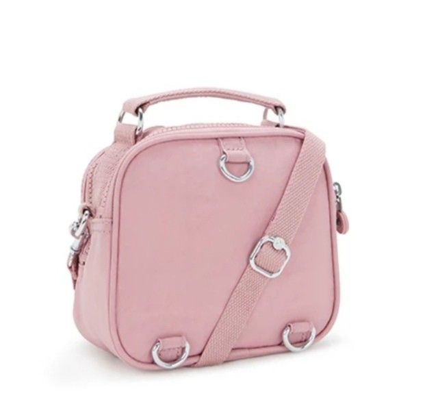 Authentic Kipling Puck Convertible Bag Flouncy Pink (Small type) (Category: Backpacks) located in Davao. Submitted by jilly07 (Listing ID 1416571030, Image 3). Description: Kipling Puck is a versatile bag that can be worn as a crossbody or carried by its top handle. It features multiple compartments for organization, including a front pocket and interior pockets. The bag comes with a detachable monkey keychain. It is a stylish and practical acces