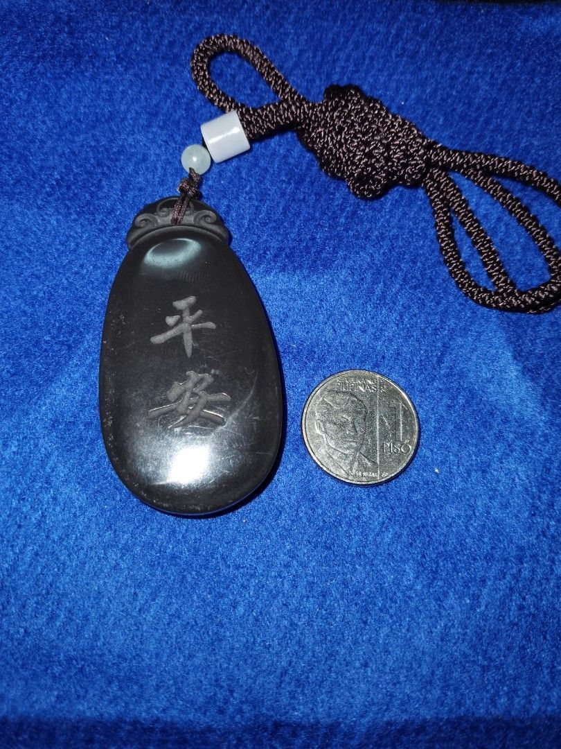 Light brown Jade Pendant with Chinese Characters (Category: Necklaces) located in Dasmarinas. Submitted by 3mi3shop (Listing ID 1416459630, Image 2). Description: Intricate light brown jade pendant with detailed carvings. Features a vase with smoke on one side and Chinese characters on the other. Includes a brown cord. A unique, dark-colored accessory. pymt thru gcash only add'l pymt for shipping fee .