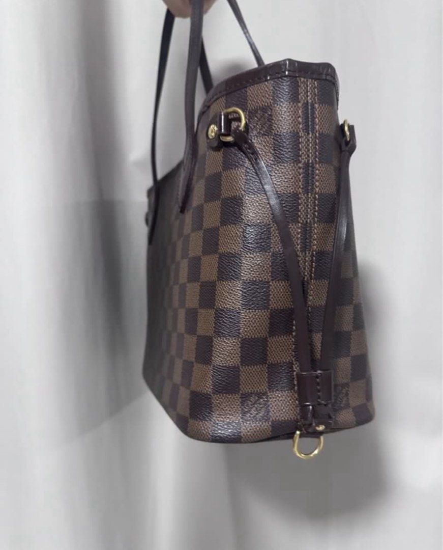 Louis Vuitton Damier Ebene Neverfull PM (Category: Luxury Bags & Wallets) located in Manila. Submitted by decluterthings888 (Listing ID 1416620890, Image 2). Description: - Authentic Louis Vuitton Neverfull pm - Damier Ebene canvas - Brown leather handles and trim - Gold-tone hardware - Spacious interior - Adjustable side laces - Stylish everyday tote.
