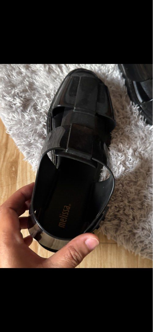 Melissa Black Sandals (Category: Flats & Sandals) located in Sual. Submitted by Twinkle (Listing ID 1416582315, Image 3). Description: - Melissa black sandals - Chunky sole - Ankle strap with buckle closure - Brand name visible on insole - Glossy, rubber-like material -worn 2x still smells like melissa .