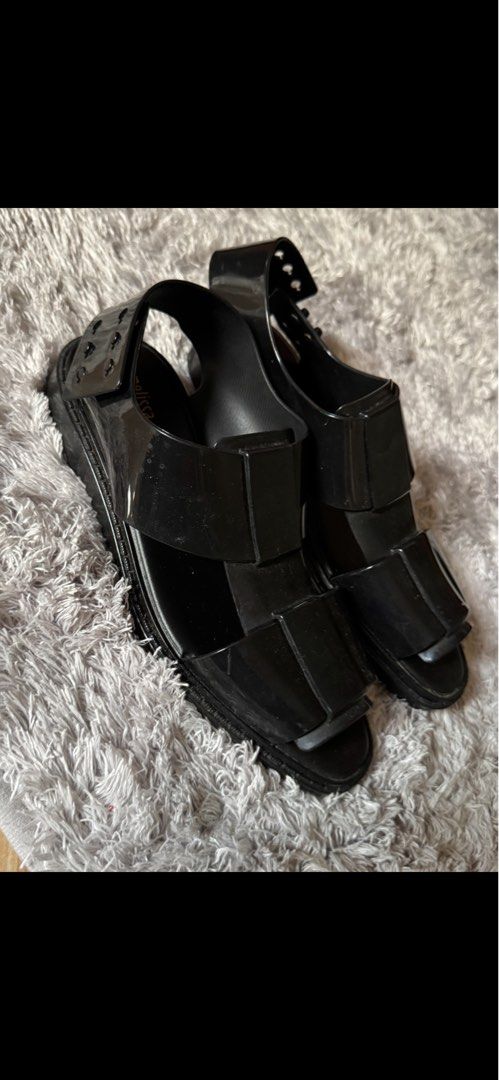 Melissa Black Sandals (Category: Flats & Sandals) located in Sual. Submitted by Twinkle (Listing ID 1416582315, Image 1). Description: - Melissa black sandals - Chunky sole - Ankle strap with buckle closure - Brand name visible on insole - Glossy, rubber-like material -worn 2x still smells like melissa .