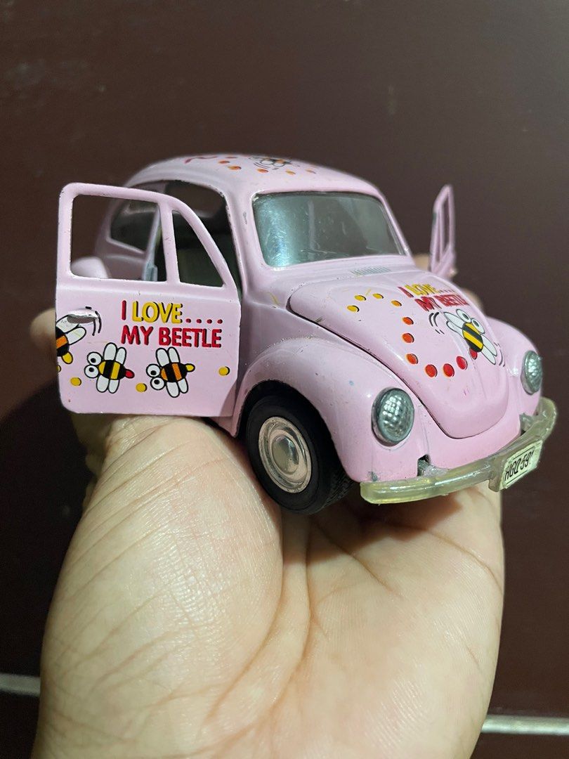 Pink Beetle Toy Car (Category: Vehicle & Diecast Models) located in Bugallon. Submitted by aennleeza (Listing ID 1416637061, Image 1). Description: - Pink toy car - "I Love My Beetle" graphics - Opening doors - Detailed interior - License plate: "HGO 591V" - Black wheels - Front bumper - Metal construction.