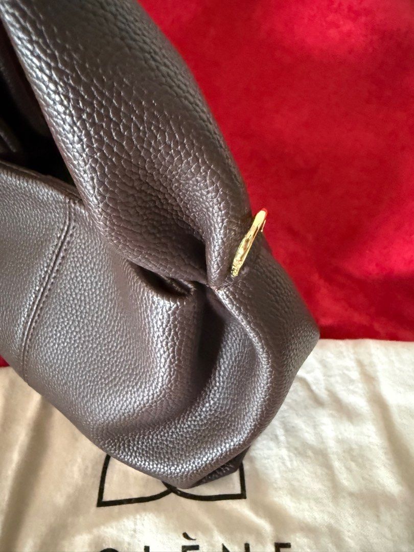 Polène Handbag (Category: Luxury Bags & Wallets) located in Quezon City. Submitted by kween_g (Listing ID 1416448274, Image 3). Description: - Brown Polène handbag - Top handle design - Elegant gold-colored hardware - Textured exterior finish - Includes dust bag - Polène logo visible -Long strap Selling for a friend. Need funds for tuition fee.