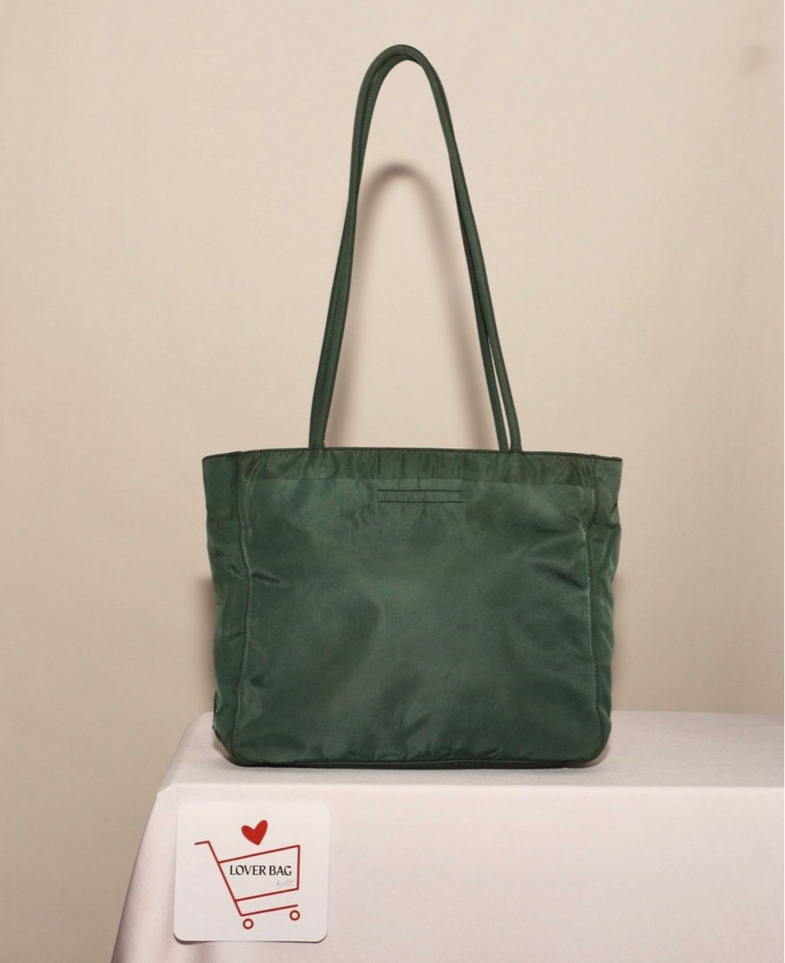 Prada Green Tote Bag (Category: Tote Bags) located in Manila. Submitted by bagrx (Listing ID 1416617028, Image 3). Description: - Authentic Prada tote bag - Color: Green - Features the Prada logo - Long handles for comfortable carrying - Spacious interior - Durable, nylon-like fabric.