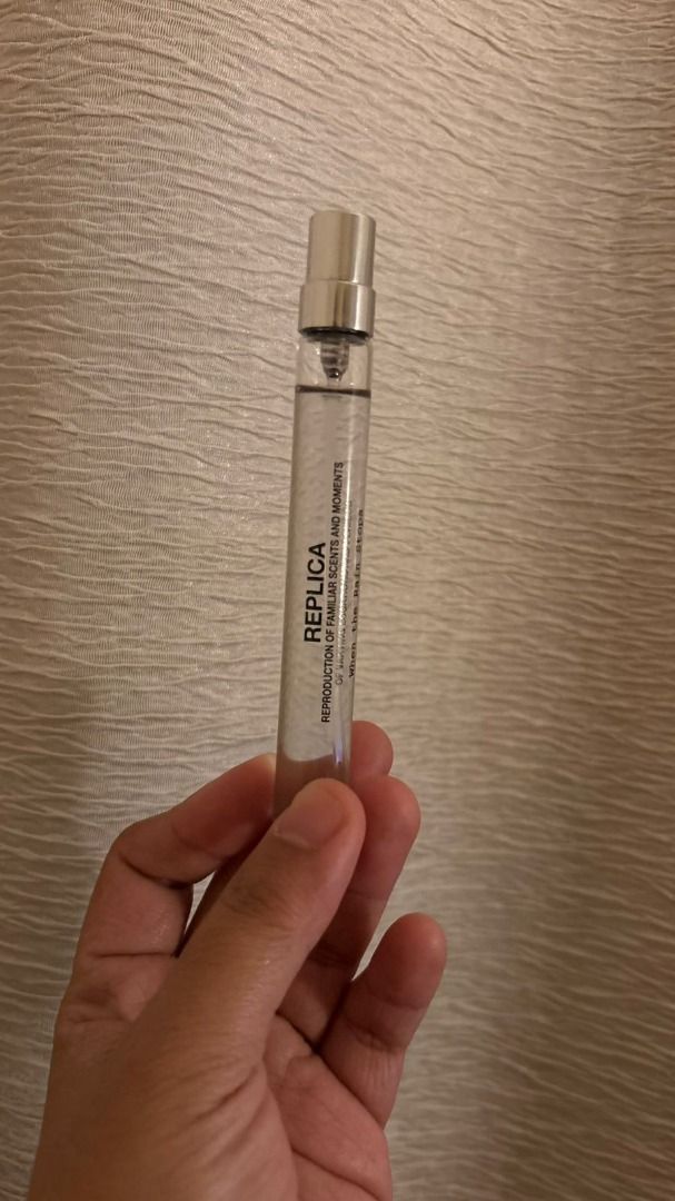 Replica Perfume Travel Size (When the Rain Stops) (Category: Fragrance & Deodorants) located in Andop. Submitted by nnikki89 (Listing ID 1416611173, Image 1). Description: - Replica travel-size perfume - Silver cap - Clear liquid - Features the 'REPLICA' label.