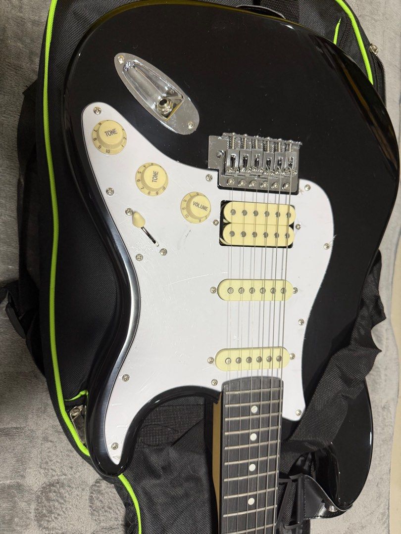 RJ Skycaster Electric Guitar with Case (Category: Musical Instruments) located in Paranaque City. Submitted by spideydream (Listing ID 1416593274, Image 1). Description: - Skycaster electric guitar in black - White pickguard and cream-colored pickups - Maple neck - Tremolo bridge - Volume and tone control knobs - Includes a black carrying case with green trim - Includes a guitar strap - Skycaster logo on headstock.