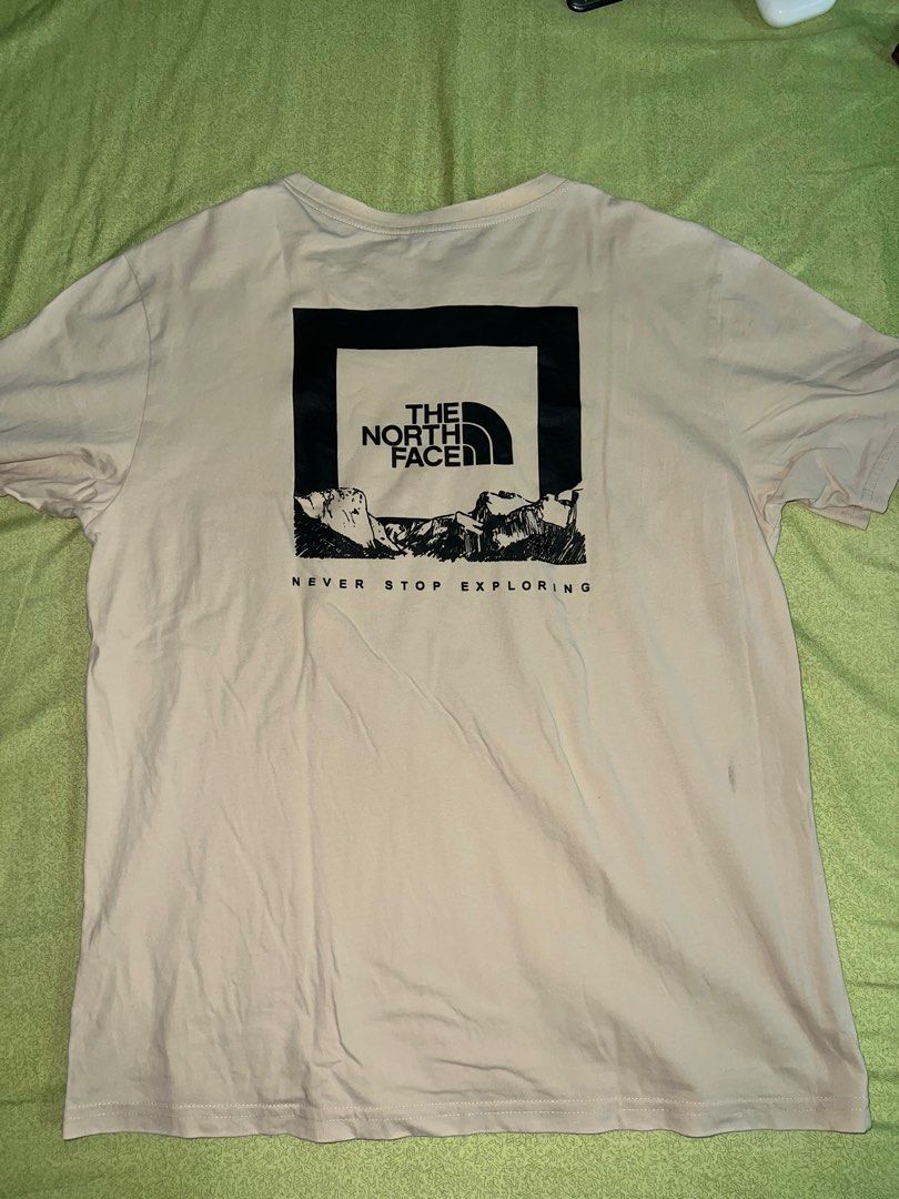 The North Face Beige Shirt (Category: Tshirts & Polo Shirts ) located in Quezon City. Submitted by declutteringpeppers (Listing ID 1416572554, Image 2). Description: - The North Face T-shirt - Dimes 18x24 in - Color: Beige - Men's size: Large - Features the North Face logo on the front - Graphic on the back with "Never Stop Exploring" text - Made in China.