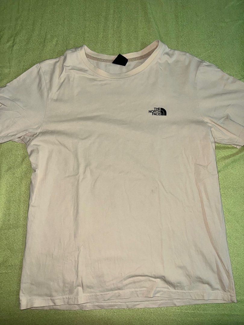 The North Face Beige Shirt (Category: Tshirts & Polo Shirts ) located in Quezon City. Submitted by declutteringpeppers (Listing ID 1416572554, Image 1). Description: - The North Face T-shirt - Dimes 18x24 in - Color: Beige - Men's size: Large - Features the North Face logo on the front - Graphic on the back with "Never Stop Exploring" text - Made in China.