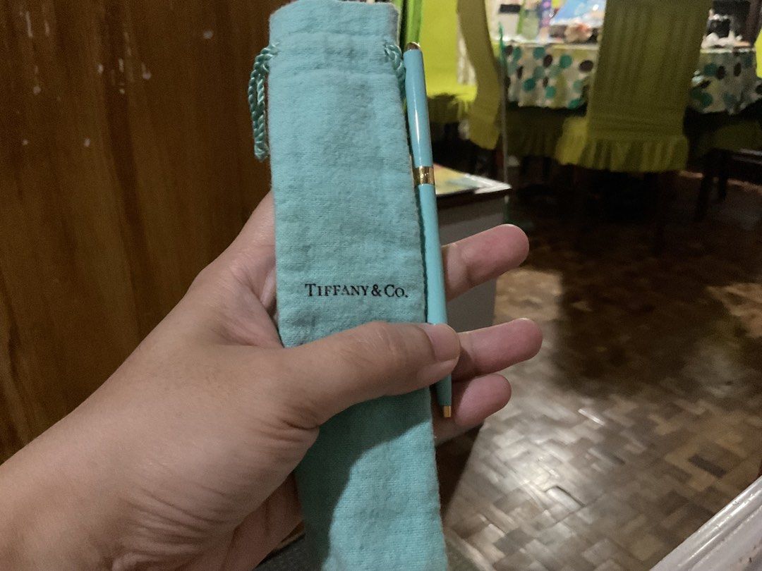 Tiffany & Co. Pen (Category: Luxury Accessories) located in San Pedro. Submitted by whatandeverdelights (Listing ID 1416452750, Image 2). Description: - Tiffany & Co. pen - Light blue color - Gold-colored accents - Includes matching pouch - Perfect for gifts or everyday use - All sales final.