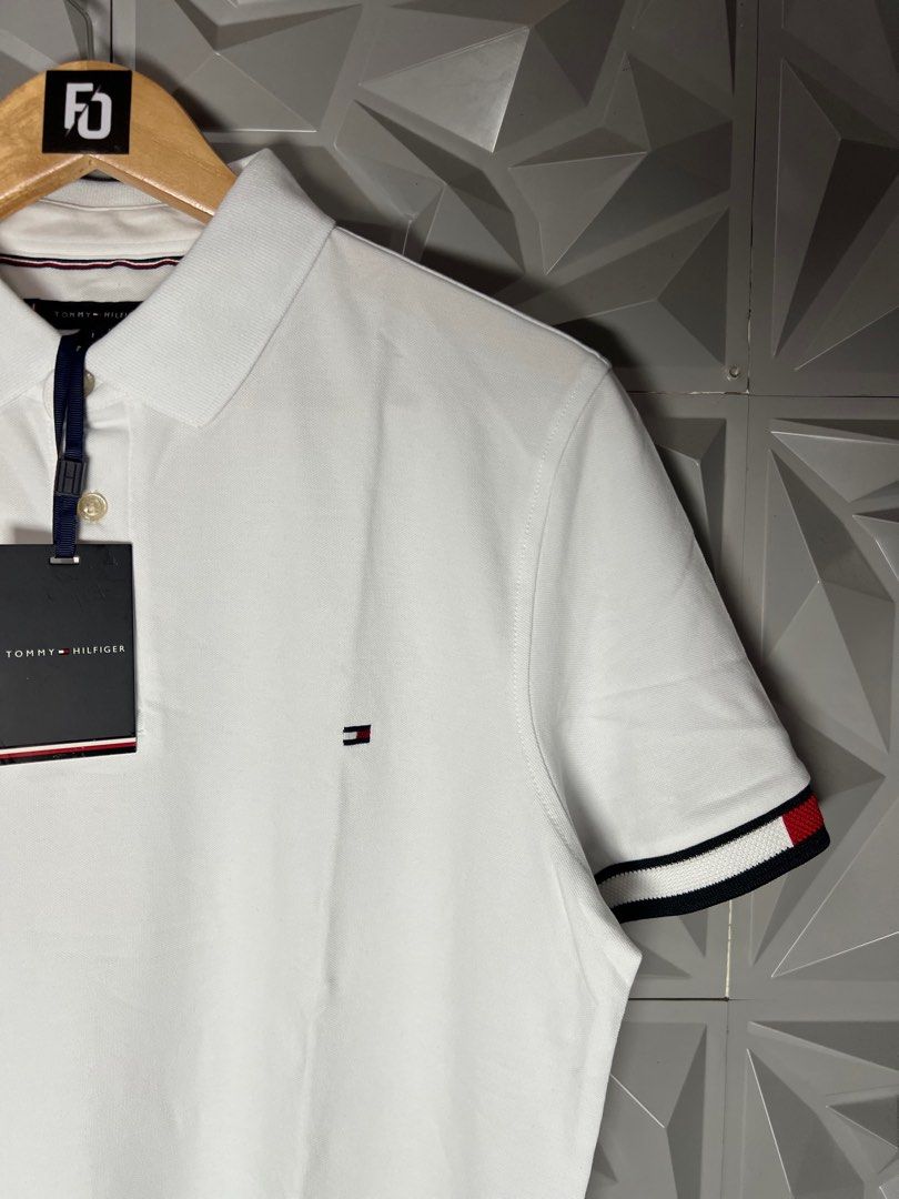Tommy Hilfiger White Polo Shirt (Category: Tshirts & Polo Shirts ) located in Taguig. Submitted by julzfausti03386 (Listing ID 1416444697, Image 3). Description: - Tommy Hilfiger polo shirt 📏 Available Sizes: • Medium – 21 x 26 • Large – 22 x 27 • XL – 23 x 28 - Short sleeves - Features Tommy Hilfiger logo - Signature colors on cuffs - Brand new with original tags - Made in Vietnam.