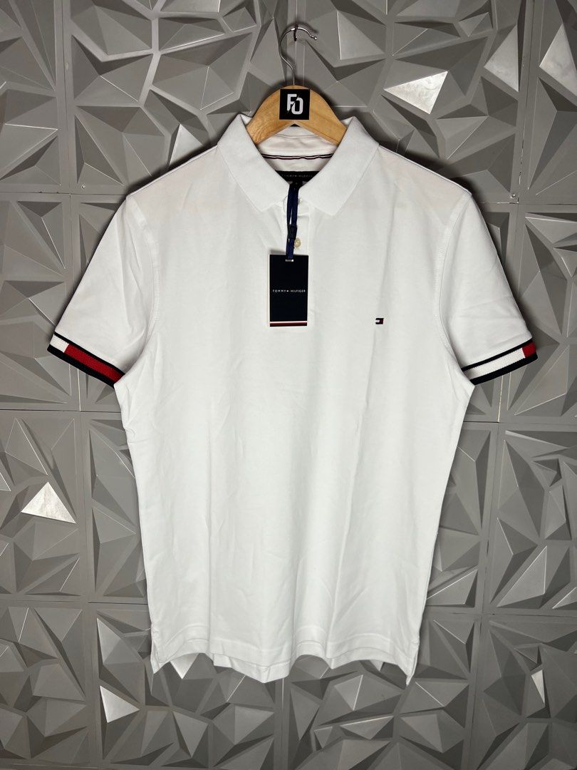 Tommy Hilfiger White Polo Shirt (Category: Tshirts & Polo Shirts ) located in Taguig. Submitted by julzfausti03386 (Listing ID 1416444697, Image 1). Description: - Tommy Hilfiger polo shirt 📏 Available Sizes: • Medium – 21 x 26 • Large – 22 x 27 • XL – 23 x 28 - Short sleeves - Features Tommy Hilfiger logo - Signature colors on cuffs - Brand new with original tags - Made in Vietnam.