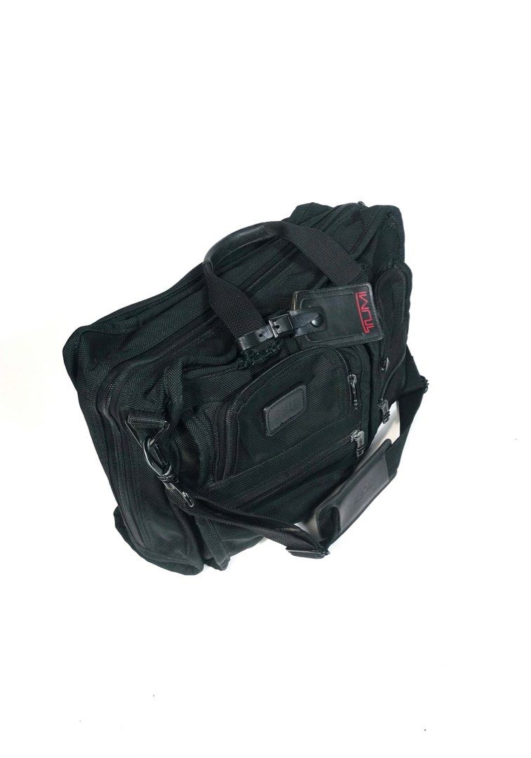 Tumi Black Briefcase (Category: Briefcases) located in Manila. Submitted by naphthrift (Listing ID 1416637284, Image 3). Description: Check out this classic Tumi black briefcase! It's got that signature Tumi durability and style, perfect for everyday use or travel. You can see it's been well-loved, but still has plenty of life left. It has multiple compartments to keep your things organized. The black color is super versatile and goes with everyt