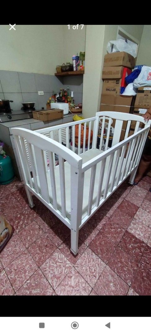White Wooden Baby Crib (Category: Cots & Cribs) located in Manila. Submitted by sher09461 (Listing ID 1416625807, Image 1). Description: - White wooden baby crib -Crib size is 28" x 48" -Made of Natural Pine Wood - Includes 3" uratex foam mattress 28"x48" - Features vertical slats and curved headboard/footboard - Expect wear and tear on the paint due to usage - Sturdy and suitable for baby -With heavy duty metal caster and stopper so you can move