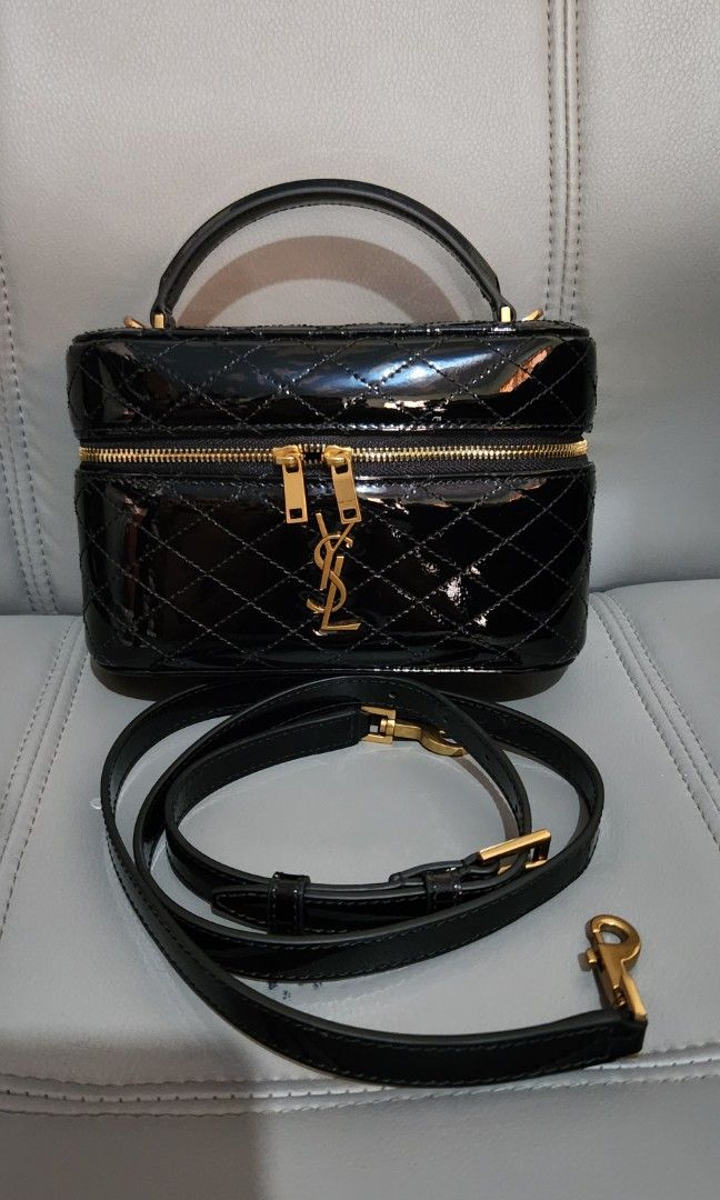 YSL Black Patent Vanity Case (Category: Luxury Bags & Wallets) located in Mabini. Submitted by wearandcarry (Listing ID 1415436418, Image 2). Description: - YSL Black Patent Leather Vanity Case - Gold-tone hardware - Quilted design - Top handle - Zip-around closure - Compact and stylish - Prominent YSL logo.
