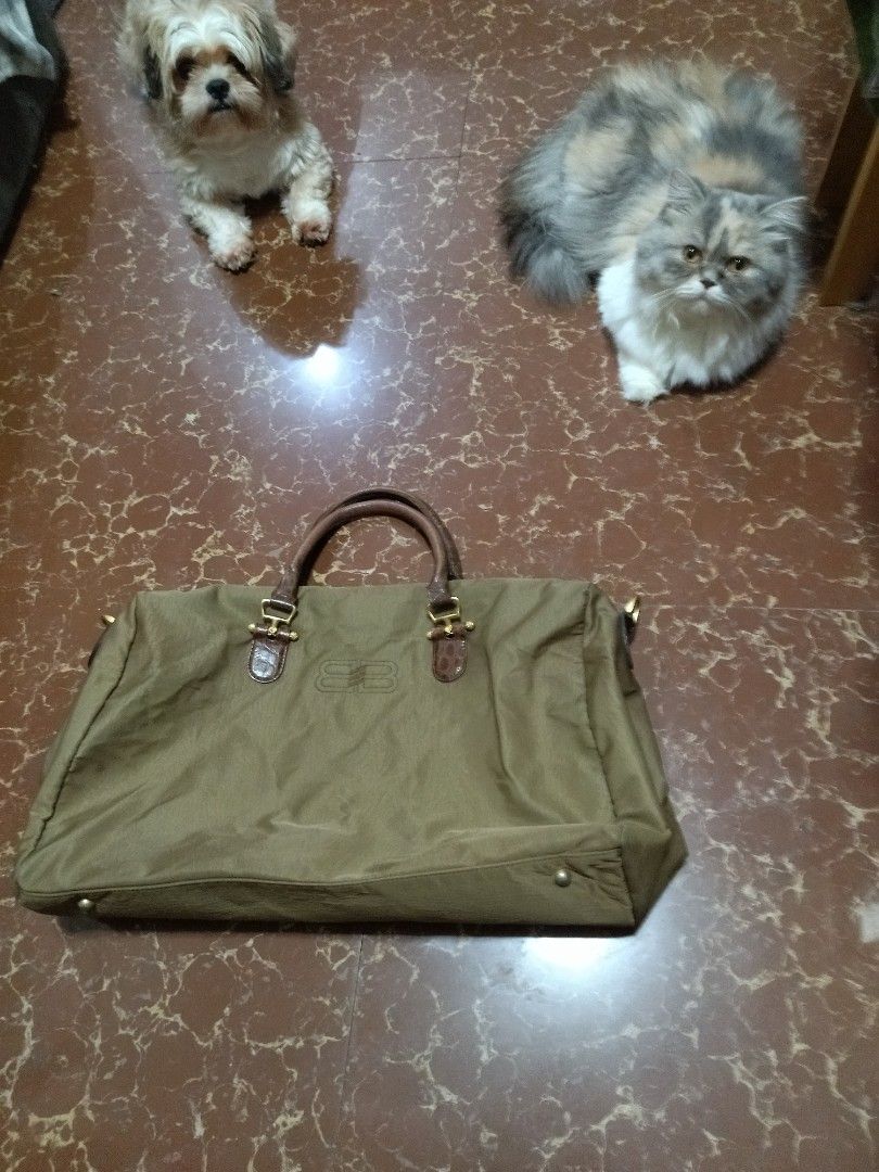 Balenciaga Travel Bag (Category: Luxury Bags & Wallets) located in Bulacan. Submitted by THA_D_THRIFT (Listing ID 1413046696, Image 3). Description: - Balenciaga travel bag - Olive green color - Brown leather handles and accents - Zippered main compartment - Small pocket - Metal logo plate inside - Minor wear on corners - Stylish and functional for travel FRESH FROM JAPAN SOURCE EXCELLENT CONDITION SIGN OF USAGE MINIMAL ISSUE SEE LAST PIC PARANG 