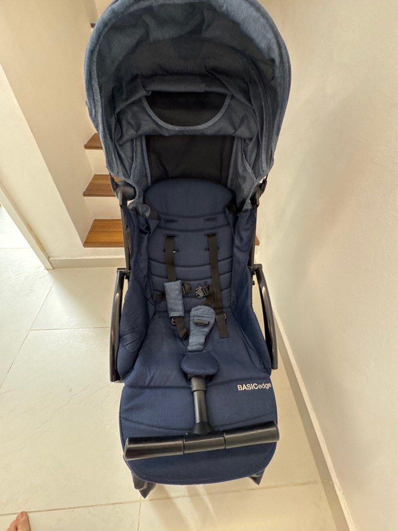 Basic Gadget Stroller (Category: Strollers) located in Kuala Lumpur. Submitted by ttee35 (Listing ID 1413110602, Image 1). Description: - Navy blue stroller - Compact and travel-friendly design - Includes sunshade - Features a safety harness - Easy-maneuvering handle - Lightweight - Branded.