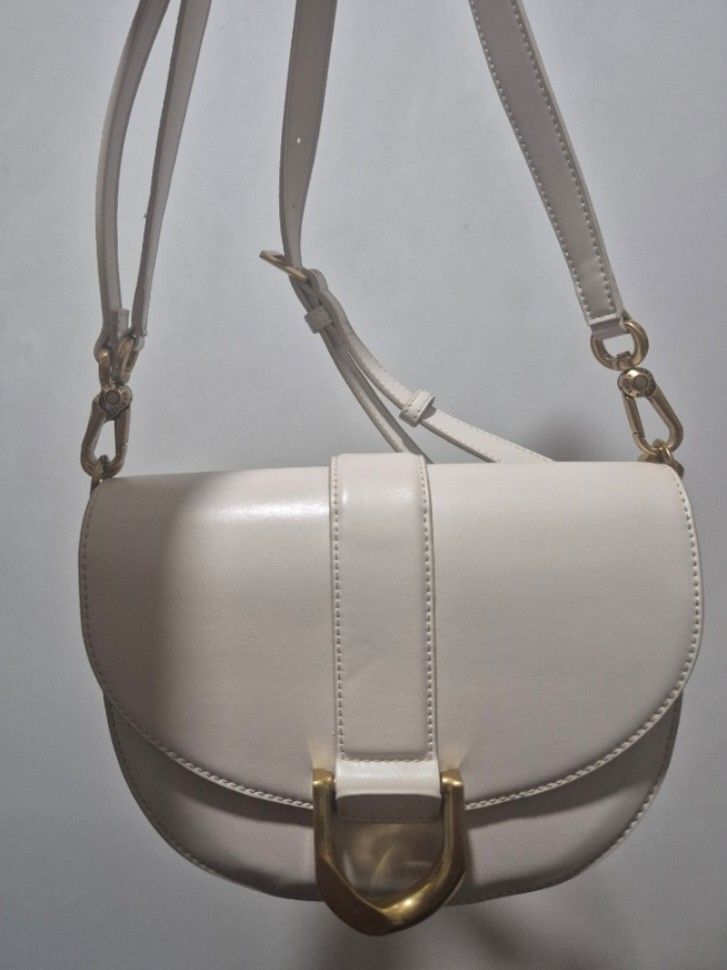 Charles & Keith Gabine Saddle Bag (Oat) (Category: Luxury Bags & Wallets) located in Cainta. Submitted by jamdgu (Listing ID 1413137981, Image 1). Description: Charles & Keith Gabine Saddle Bag in Oat Bought from Singapore Rarely used In excellent condition, with pouch MOP: Maya, GCash, BPI, UnionBank, GoTyme Delivery: J&T, Lalamove Loc: Cainta.