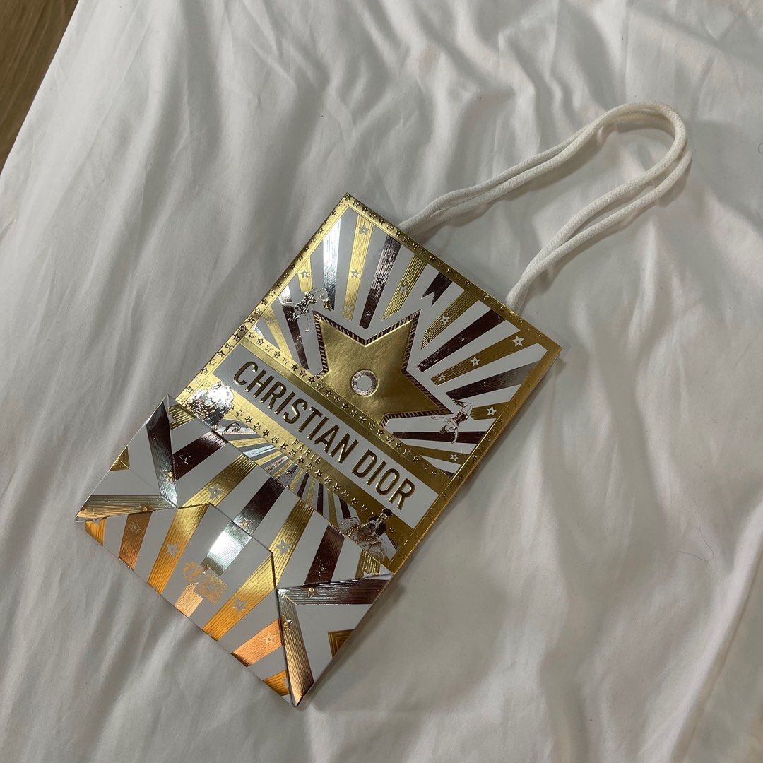 Christian Dior Paper Bag (Category: Luxury Bags & Wallets) located in Quezon City. Submitted by shop_angela (Listing ID 1413084384, Image 3). Description: Authentic Christian Dior paper bag. Gold and white design with logo. Includes rope handles. Perfect for gifting or collecting..