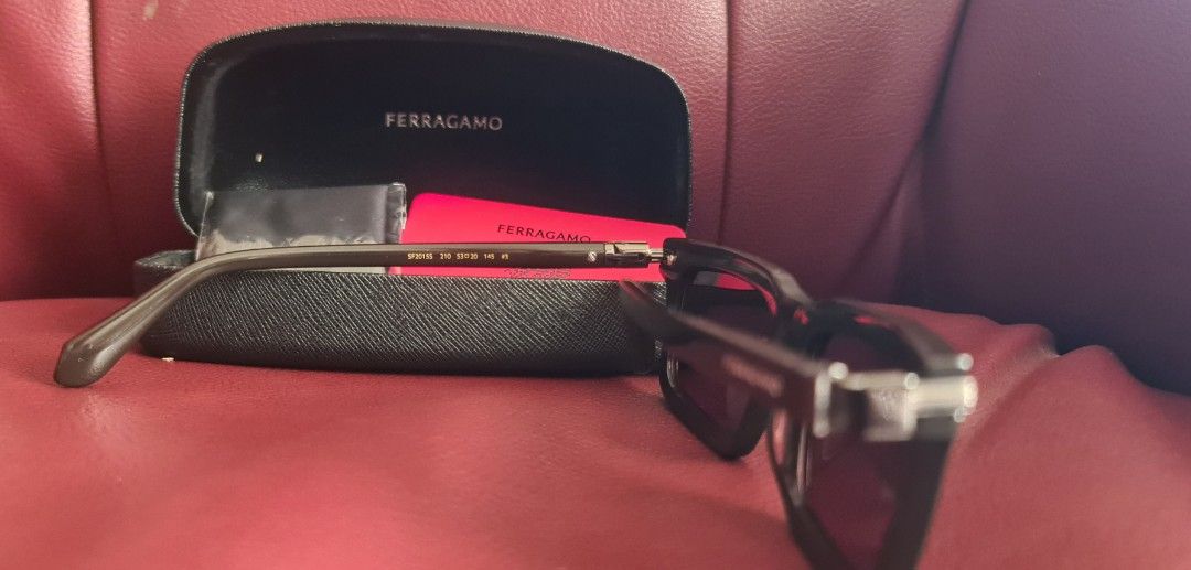Ferragamo Sunglasses sf2015s (Category: Sunglasses & Eyewear) located in Las Pinas. Submitted by monjoy2011 (Listing ID 1413138002, Image 2). Description: - Authentic Ferragamo sunglasses - Includes original case, cleaning cloth, and authenticity card - Dark-colored, rectangular frame - Made in Italy - Model number visible on arm - Perfect for everyday wear -Gifted to me from us.