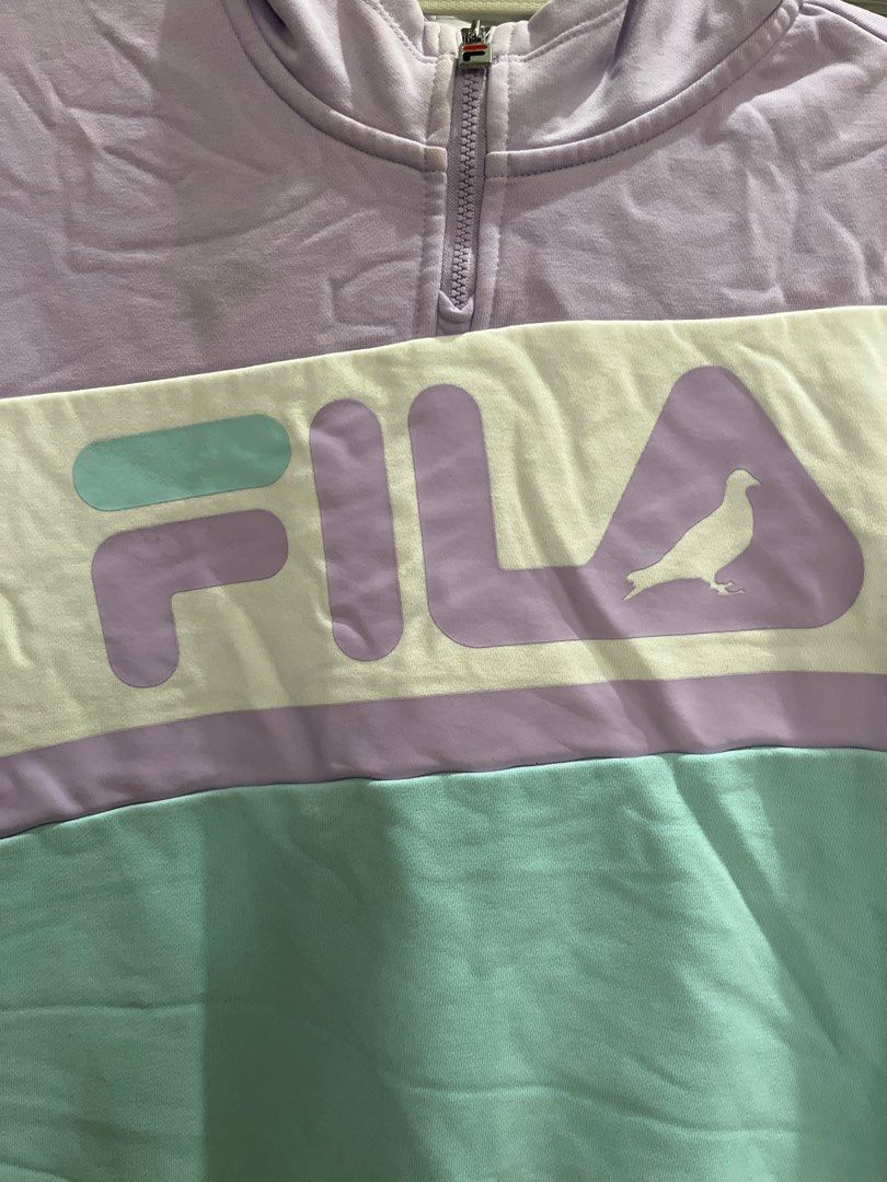Fila Staple Pigeon Hoodie (Category: Hoodies) located in Valenzuela. Submitted by gengen13 (Listing ID 1413076543, Image 2). Description: - Fila color block hoodie - 19x21.5 inches (widthxLength) - Unique design: Purple, white, and teal - Half-zip closure - Hooded - Features Fila and Staple Pigeon logos - Made of cotton and polyester blend - Size: 160/80A With stain. Baka pwede pa mkuha sa laba Intact zip and rivings Can pass as new nagkastain ln