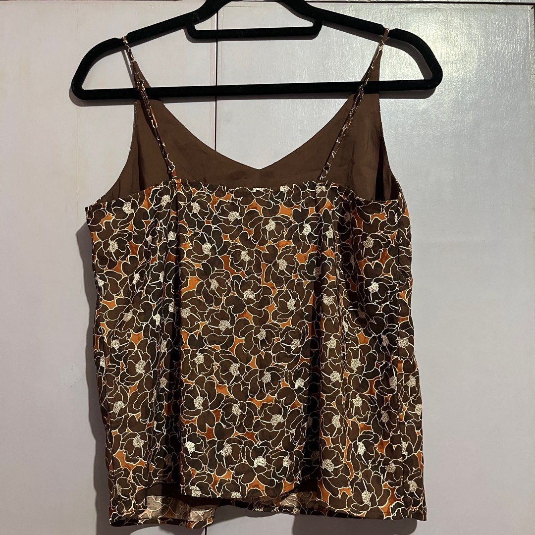 Floral Print Camisole Top (Category: Sleeveless) located in Pasig City. Submitted by ajdlsrysx (Listing ID 1413197614, Image 2). Description: - Floral print camisole - Colors: Brown, white, orange - Features: V-neck, spaghetti straps - Lightweight and breathable fabric - Perfect for warm weather - Versatile for various outfits.