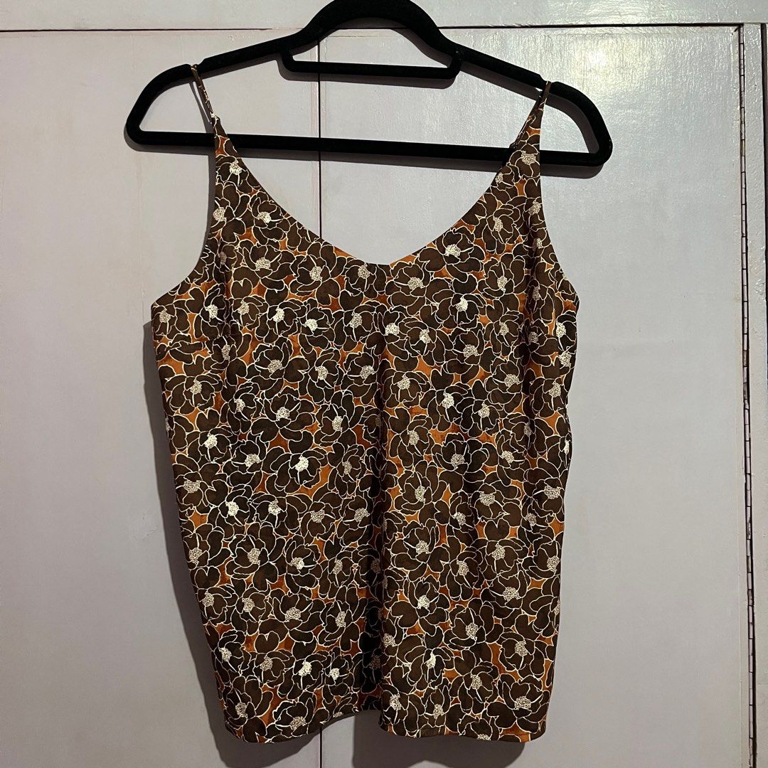 Floral Print Camisole Top (Category: Sleeveless) located in Pasig City. Submitted by ajdlsrysx (Listing ID 1413197614, Image 1). Description: - Floral print camisole - Colors: Brown, white, orange - Features: V-neck, spaghetti straps - Lightweight and breathable fabric - Perfect for warm weather - Versatile for various outfits.