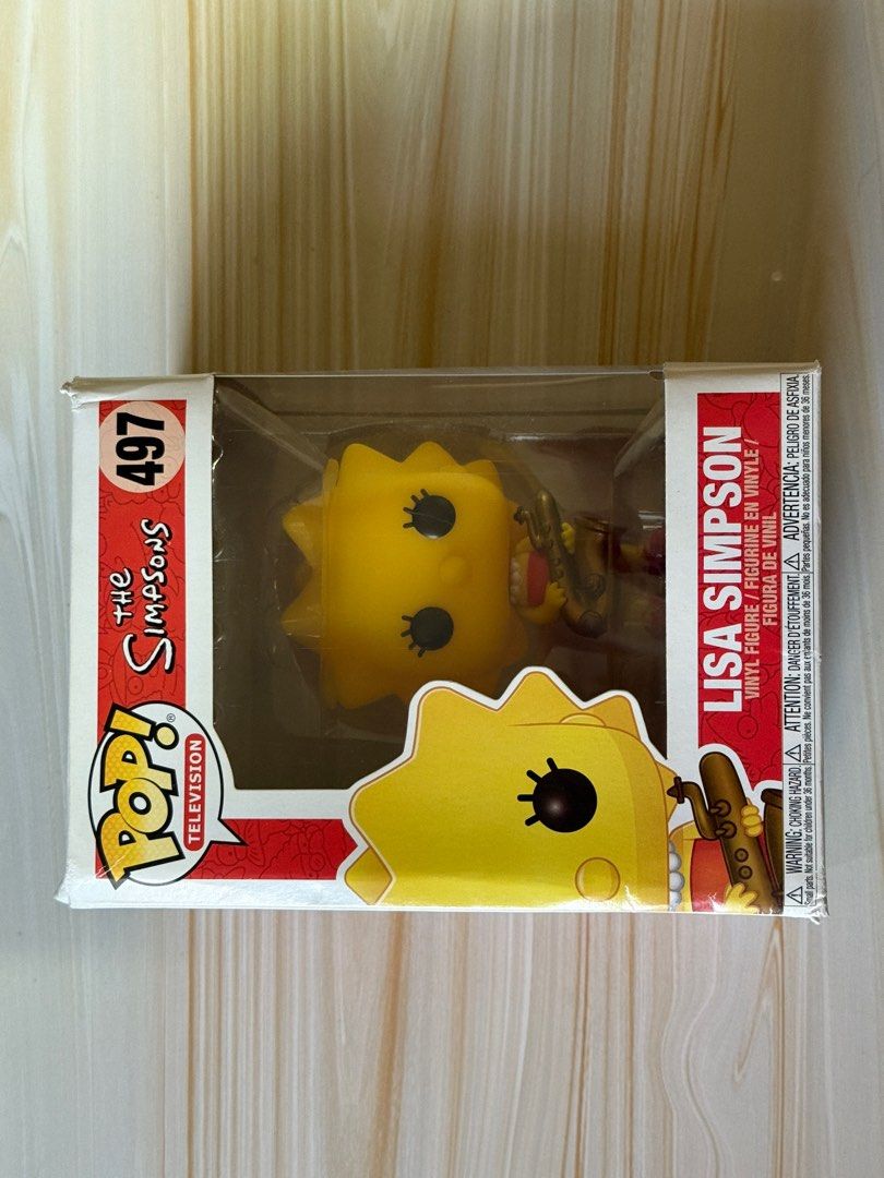 Funko Pop! Television: The Simpsons - Lisa Simpson #497 (Category: Designer & Blind Box Toys) located in Bacoor. Submitted by nixxpreloved (Listing ID 1413089057, Image 1). Description: - Funko Pop! figure of Lisa Simpson from The Simpsons. - Part of the Pop! Television series, #497. - Figure is in its original packaging. - Box features Lisa with her saxophone. - Back of the box displays other Simpsons characters..