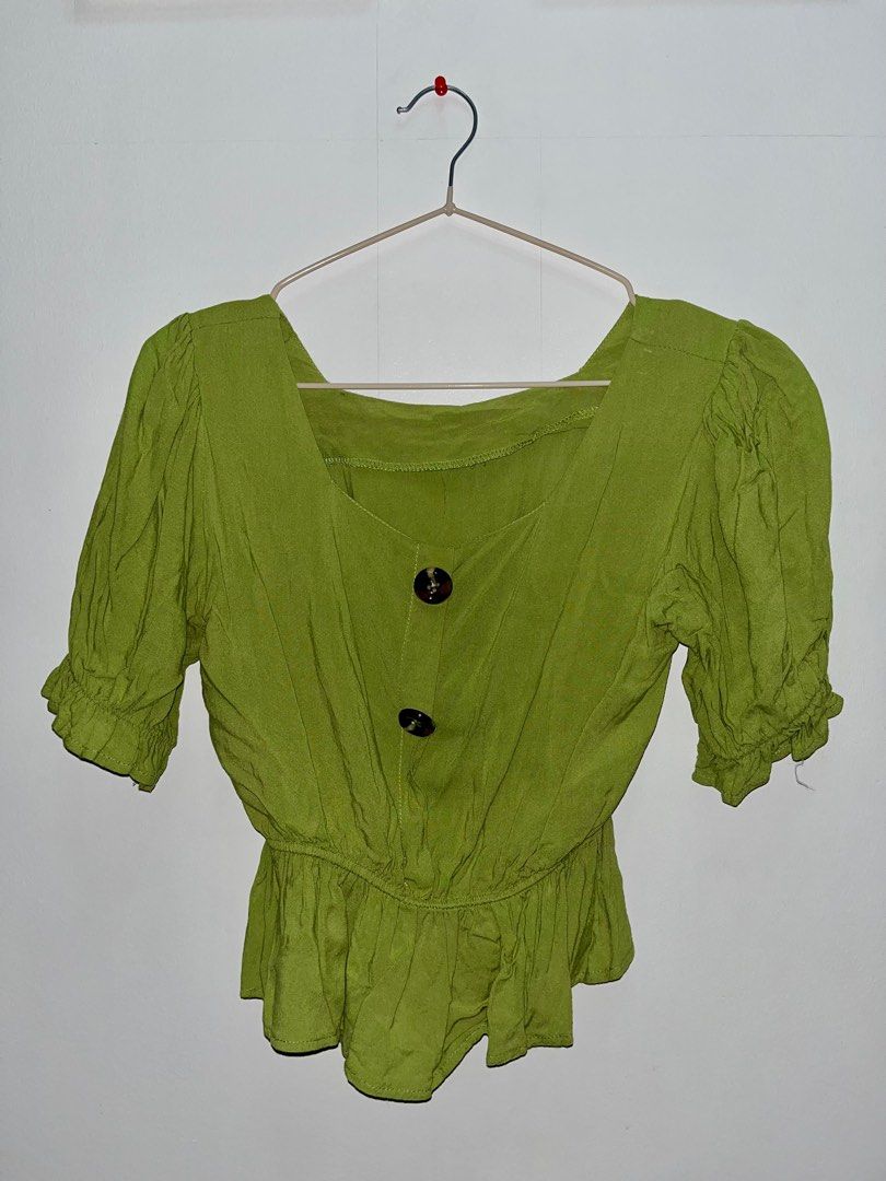 Green Button-Up Top (Category: Blouses) located in Las Pinas. Submitted by leimooonade (Listing ID 1413145878, Image 1). Description: - Green button-up top - Square neckline - Short sleeves - Ruffled hem - Two-button closure - Ruffled cuffs Size: can fit from S-M GCash ONLY ‼️.