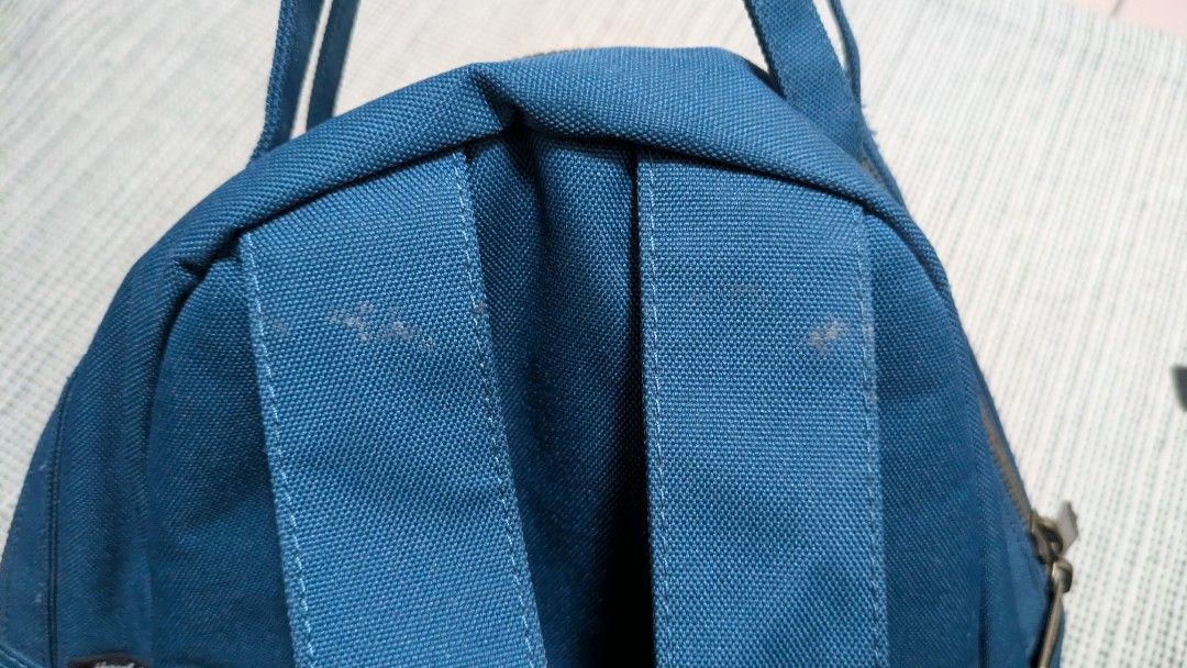 Herschel Nova Mini Backpack - Blue (Category: Backpacks) located in Singapore. Submitted by hazelnut___ (Listing ID 1413164958, Image 2). Description: - Features a front pocket. - Includes a top handle. - Minor stain on image 2..