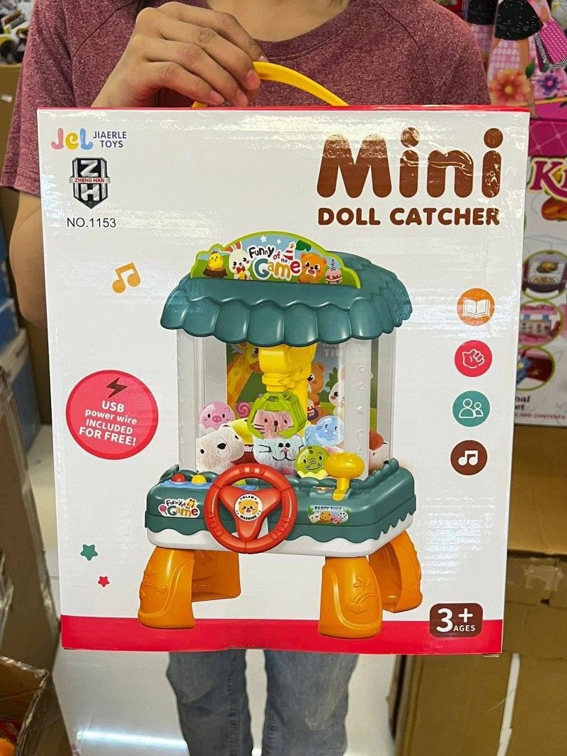 Jiaerle Toys Mini Doll Catcher (Category: Kids Toys) located in Manila. Submitted by rocillocin64338 (Listing ID 1413114938, Image 2). Description: - Jiaerle Toys Mini Doll Catcher - Mechanical claw, music, and lights - Includes toys and USB power wire - Steering wheel and control lever - Easy to play: Load balls and dolls, transfer to exit - Plays applause and cheers when you win - Suitable for ages 3+.