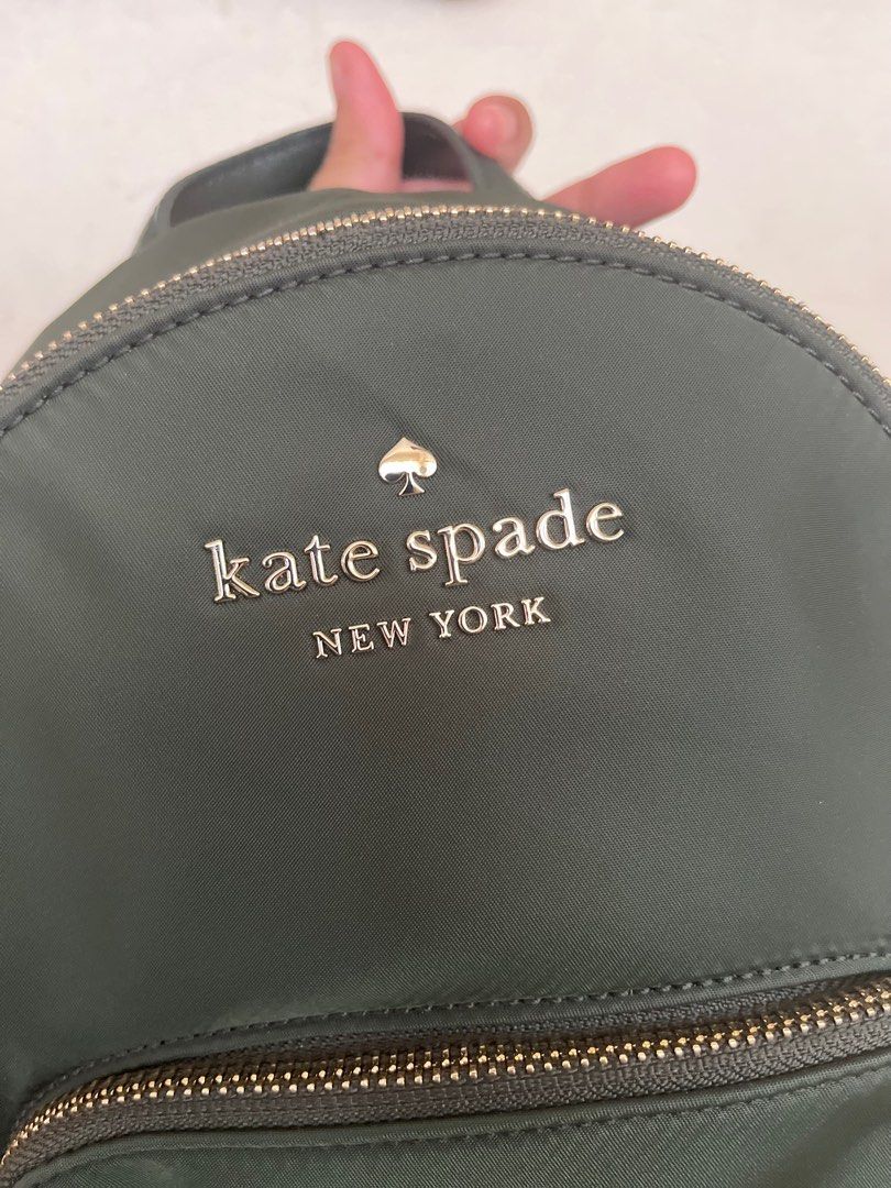 Kate Spade Olive Green Backpack (Category: Backpacks) located in Bulacan. Submitted by nyawnyaww (Listing ID 1413216475, Image 3). Description: - Kate Spade backpack - Olive green color - Pink and black striped straps - Gold-toned zippers - Front pocket - Interior pocket - Includes small pouch Guaranteed og.