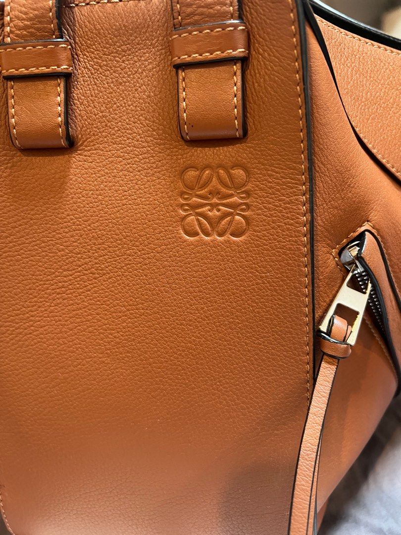 Loewe Hammock Small Bag Authentic with Receipt (Category: Luxury Bags & Wallets) located in Manila. Submitted by cubbyhole525928 (Listing ID 1413170569, Image 2). Description: - Loewe Hammock Small Bag - Color: Brown - Size: Small - Features: - Zip closure - Detachable strap - Embossed Loewe logo - Interior: Black fabric lining - Includes: Original receipt - Origin: bought from Hong Kong - has a small tear at the bottom and had it fixed by Dr. ba
