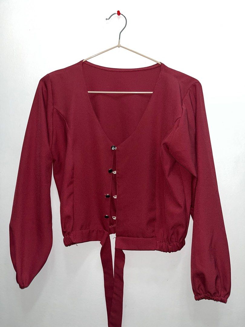 Maroon Long Sleeve Blouse (Category: Blouses) located in Las Pinas. Submitted by leimooonade (Listing ID 1413149047, Image 1). Description: - Maroon long-sleeved blouse - V-neckline - Button-down front - Waist tie detail - Slight puff sleeves with gathered cuffs - Smooth, satin-like fabric GCash ONLY ‼️.