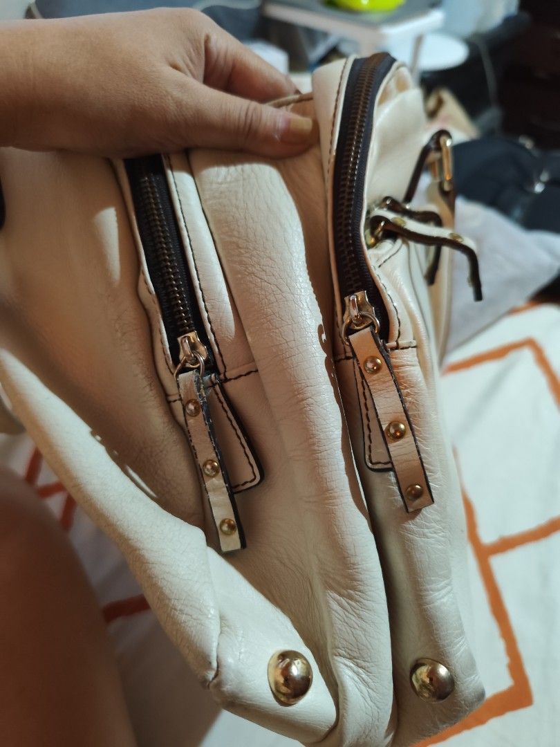 Miu Miu offwhite Handbag (Category: Luxury Bags & Wallets) located in Makati City. Submitted by call_me_biggy (Listing ID 1413104754, Image 3). Description: - Off white Miu Miu handbag - light gold tone hardware - Dual top handles - Zip closure - Exterior zip pockets - Main compartment with brand label - provided sling but not the same brand - Classic shape - Made of leather - Authenticity not guaranteed.