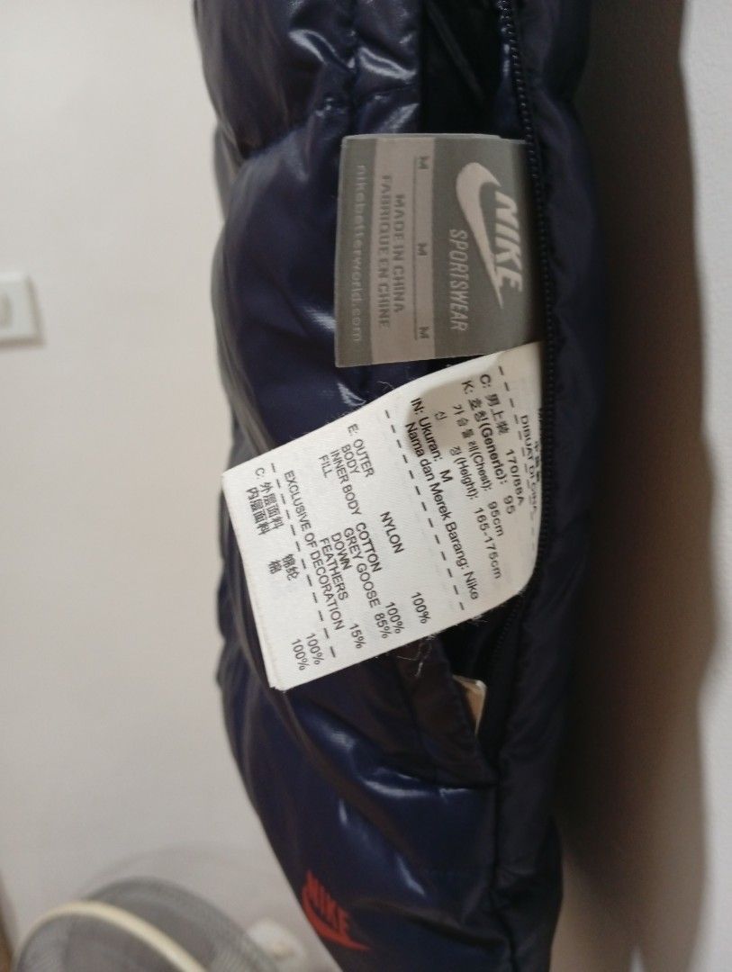 Nike Reversible Puffer Vest (Category: Vests) located in Quezon City. Submitted by mcenon35 (Listing ID 1413195255, Image 3). Description: - Nike reversible vest - Features: Navy blue puffer side & red plaid pattern - Button-up closure - Two pockets on the navy side - Small Nike logo - Size: Medium - Made in China.