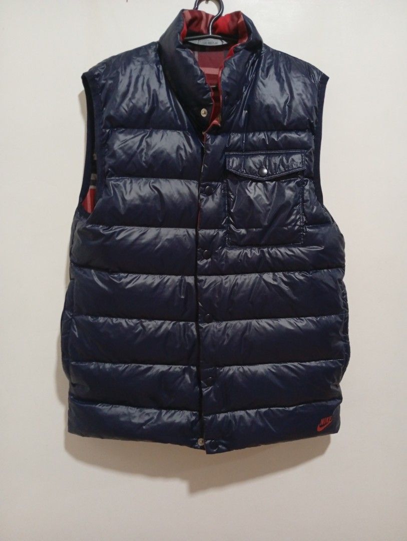 Nike Reversible Puffer Vest (Category: Vests) located in Quezon City. Submitted by mcenon35 (Listing ID 1413195255, Image 1). Description: - Nike reversible vest - Features: Navy blue puffer side & red plaid pattern - Button-up closure - Two pockets on the navy side - Small Nike logo - Size: Medium - Made in China.