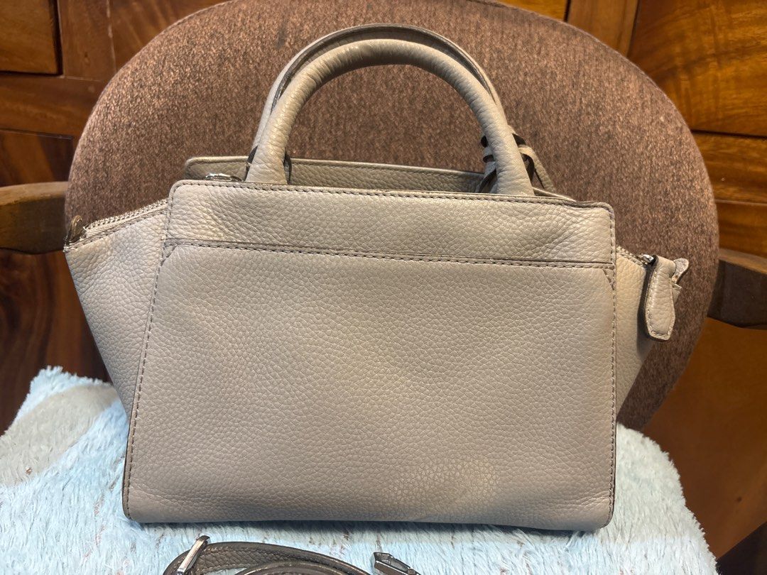 Oryany 2 way gray leather bag (Category: Luxury Bags & Wallets) located in Imus. Submitted by bagsofblessings24 (Listing ID 1413077735, Image 2). Description: Original Oryany 2 way bag 9 in x 6.5 in x bottom 5in Structured, light weight, genuine leather Handbag features a stylish design with a top handle and an additional shoulder strap. It has a main compartment with a zipper closure and an interior pocket. The bag is adorned with a decorative p