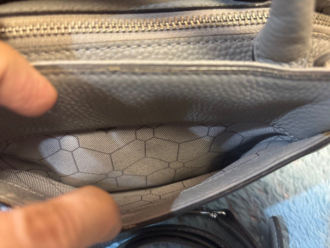 Oryany 2 way gray leather bag (Category: Luxury Bags & Wallets) located in Imus. Submitted by bagsofblessings24 (Listing ID 1413077735, Image 3). Description: Original Oryany 2 way bag 9 in x 6.5 in x bottom 5in Structured, light weight, genuine leather Handbag features a stylish design with a top handle and an additional shoulder strap. It has a main compartment with a zipper closure and an interior pocket. The bag is adorned with a decorative p
