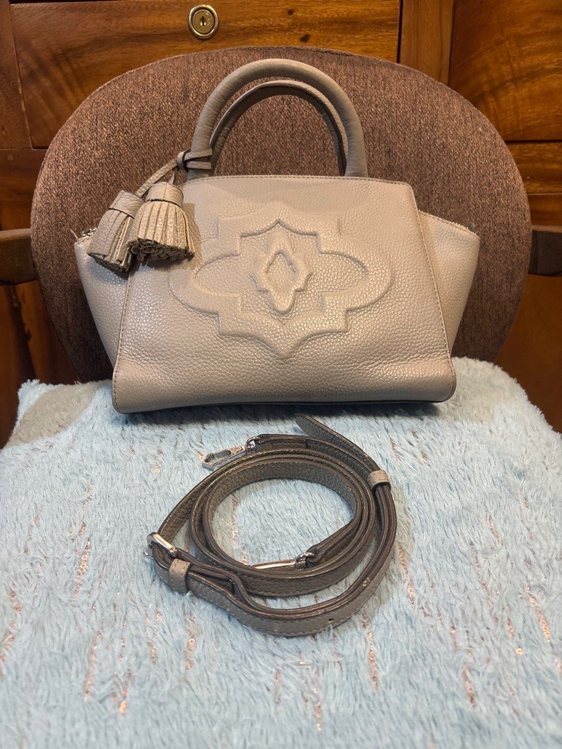Oryany 2 way gray leather bag (Category: Luxury Bags & Wallets) located in Imus. Submitted by bagsofblessings24 (Listing ID 1413077735, Image 1). Description: Original Oryany 2 way bag 9 in x 6.5 in x bottom 5in Structured, light weight, genuine leather Handbag features a stylish design with a top handle and an additional shoulder strap. It has a main compartment with a zipper closure and an interior pocket. The bag is adorned with a decorative p