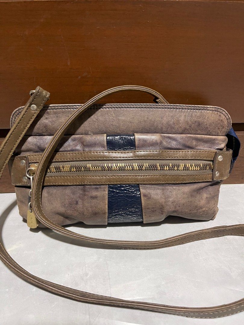 See By Chloe Leather Shoulder Bag (Category: Luxury Bags & Wallets) located in Bacnotan. Submitted by anosellmo (Listing ID 1413073899, Image 2). Description: - See By Chloe shoulder bag - Bronze color with navy blue accent - Long strap for shoulder or crossbody wear - Zipper closure - Small lock detail - Lined interior - Includes brand label.