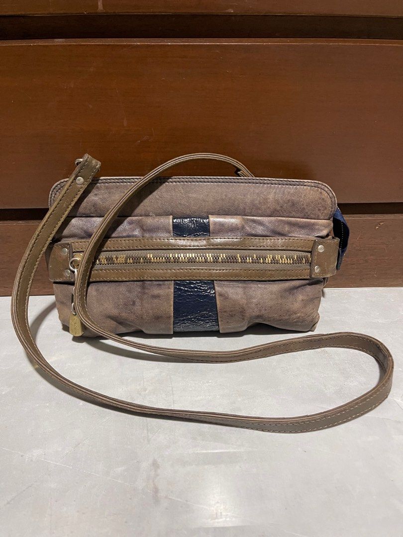 See By Chloe Leather Shoulder Bag (Category: Luxury Bags & Wallets) located in Bacnotan. Submitted by anosellmo (Listing ID 1413073899, Image 1). Description: - See By Chloe shoulder bag - Bronze color with navy blue accent - Long strap for shoulder or crossbody wear - Zipper closure - Small lock detail - Lined interior - Includes brand label.