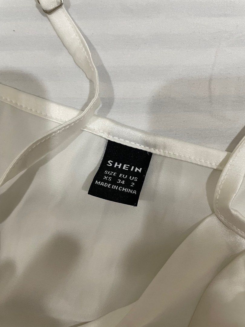 Shein White Satin Top XS (Category: Blouses) located in Quezon City. Submitted by jackiedc (Listing ID 1413140459, Image 2). Description: - Shein white satin top - Size: XS - Features adjustable straps - Cowl neckline - Slightly asymmetrical hem - Made of smooth, silky material - Perfect for skirts or pants.
