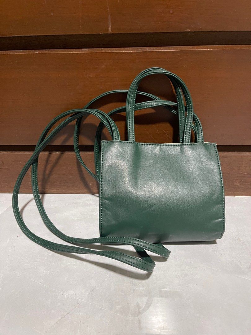 Telfar Shopping Bag Small Dark Green (Category: Luxury Bags & Wallets) located in Bacnotan. Submitted by anosellmo (Listing ID 1413073236, Image 3). Description: - Telfar Small Shopping Bag - Color: Dark Green - Features: - Top handle - Long strap (shoulder/crossbody) - Telfar logo - Interior: Branded tag.