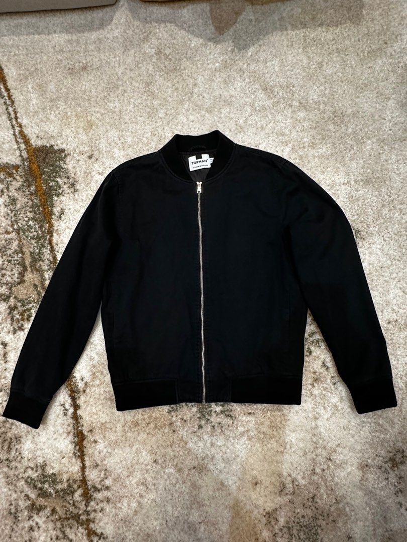 Topman Black Bomber Jacket (Category: Coats, Jackets and Outerwear) located in Manila. Submitted by karltrinidad (Listing ID 1413192002, Image 1). Description: - Topman black bomber jacket - Zip-up front - Ribbed collar, cuffs, and hem - Classic bomber style - Measurements in images - Versatile for various outfits.