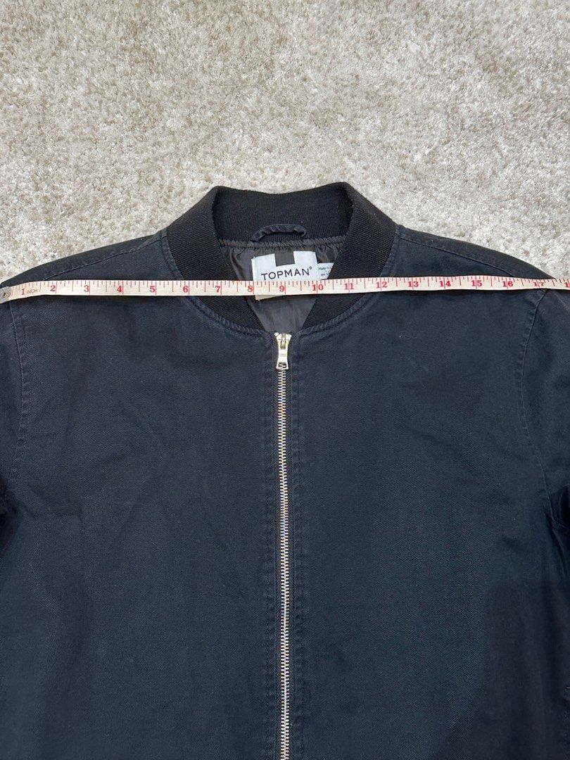 Topman Black Bomber Jacket (Category: Coats, Jackets and Outerwear) located in Manila. Submitted by karltrinidad (Listing ID 1413192002, Image 2). Description: - Topman black bomber jacket - Zip-up front - Ribbed collar, cuffs, and hem - Classic bomber style - Measurements in images - Versatile for various outfits.