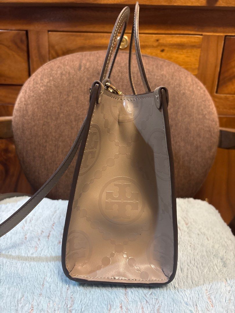 Tory Burch Perry Top-Zip Tote Bag (Category: Luxury Bags & Wallets) located in Imus. Submitted by bagsofblessings24 (Listing ID 1413166212, Image 2). Description: - Preloved Tory Burch 2way medium taupe bag - Top-zip closure - Detachable shoulder strap - Beige exterior with Tory Burch logo pattern - Structured shape - Top handle - Spacious interior - Interior slip pocket - Made of PVC leather Taupe color 10 in x 7.5 in x 3.5 bottom in For self au