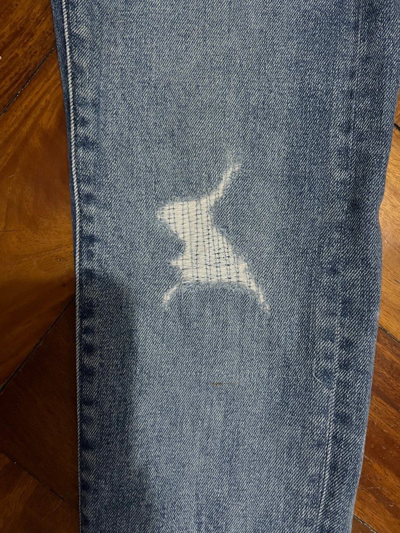 Uniqlo Distressed Jeans - Size 28 (Category: Jeans) located in Bacoor. Submitted by pastforward.ph (Listing ID 1413130328, Image 3). Description: - Uniqlo jeans - Light blue wash - Distressed detailing - Size 28 (70cm) - Made in Vietnam - Minor wear and tear, some stains - Classic five-pocket design - Button and zipper closure.