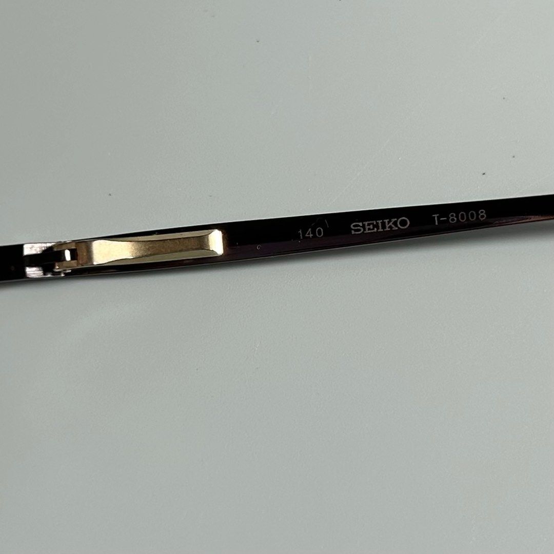 Vintage Seiko Titanium Eyeglasses (Category: Sunglasses & Eyewear) located in Cavite. Submitted by datsoretro (Listing ID 1413209317, Image 2). Description: Please check photos for current condition. Seiko T-8008 eyeglasses. Features a titanium frame and nose pads. The frame is a dark brown color. The glasses are marked "Made in Japan". The frame size is 54 15 and the temple length is 140..