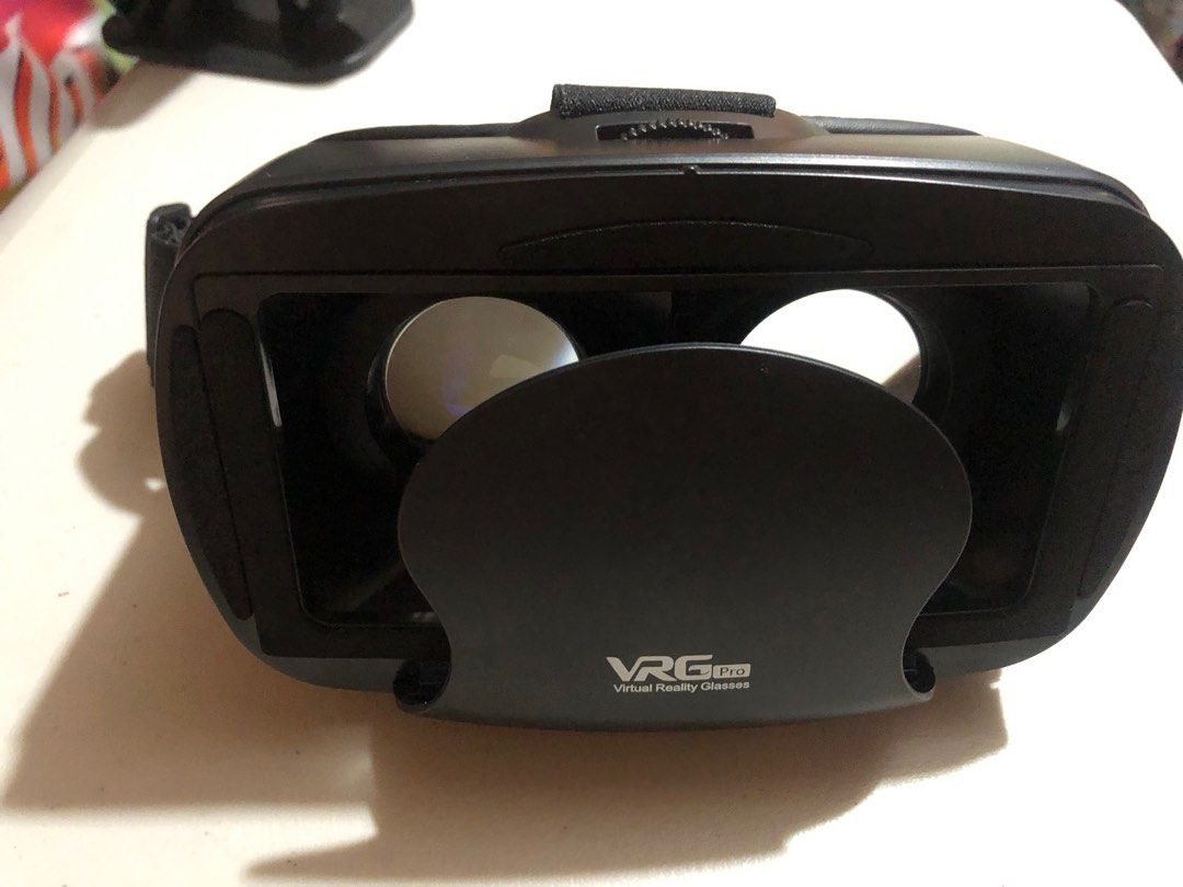 VRG Pro Virtual Reality Glasses with Controller (Category: Virtual Reality) located in Quezon City. Submitted by luckykikyo (Listing ID 1413128837, Image 3). Description: - VRG Pro VR headset with controller - Black headset - White controller with multiple buttons - Adjustable lenses - Comfortable design - Designed for smartphone VR - Includes original box.