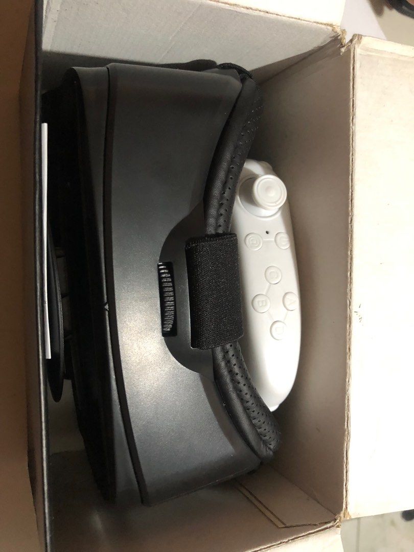 VRG Pro Virtual Reality Glasses with Controller (Category: Virtual Reality) located in Quezon City. Submitted by luckykikyo (Listing ID 1413128837, Image 1). Description: - VRG Pro VR headset with controller - Black headset - White controller with multiple buttons - Adjustable lenses - Comfortable design - Designed for smartphone VR - Includes original box.